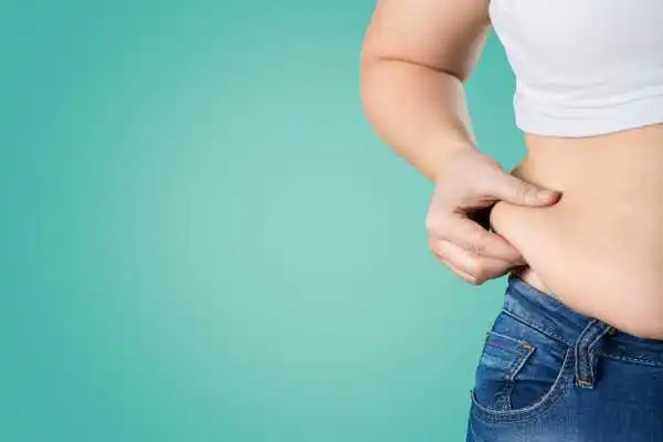 Image of woman pinching her love handles to show weight gain Underwood